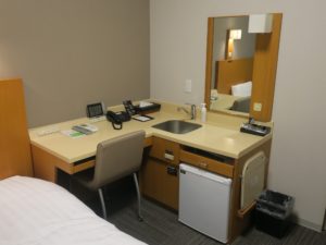 ドーミーイン富山 シングルルーム デスク回り 洗面台がデスクの横にあります