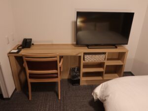 ドーミーイン広島ANNEX ダブルルーム デスク回り 液晶テレビと電話、メモ帳があります