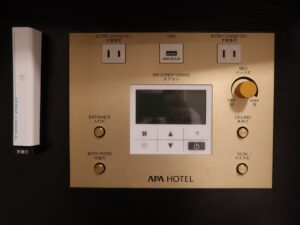 アパホテル 千葉駅前 スタンダードルーム 枕元 エアコンと明かりのスイッチ、ACコンセント、USBポート、非常灯があります